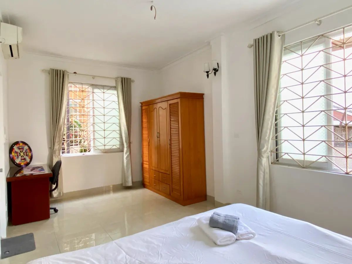 Modern, airy bedroom with large windows