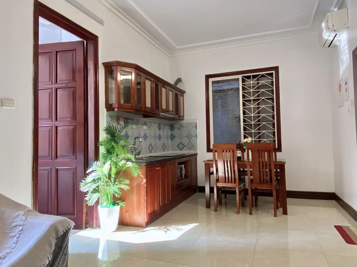 Cozy kitchenette with stove, fridge, and utensils, perfect for home cooking.