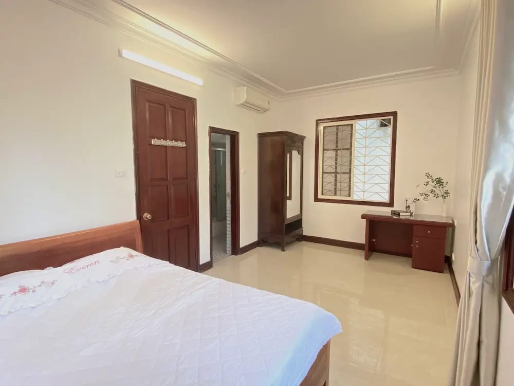 Spacious bedroom with comfortable queen bed, ideal for couples visiting Hanoi.”